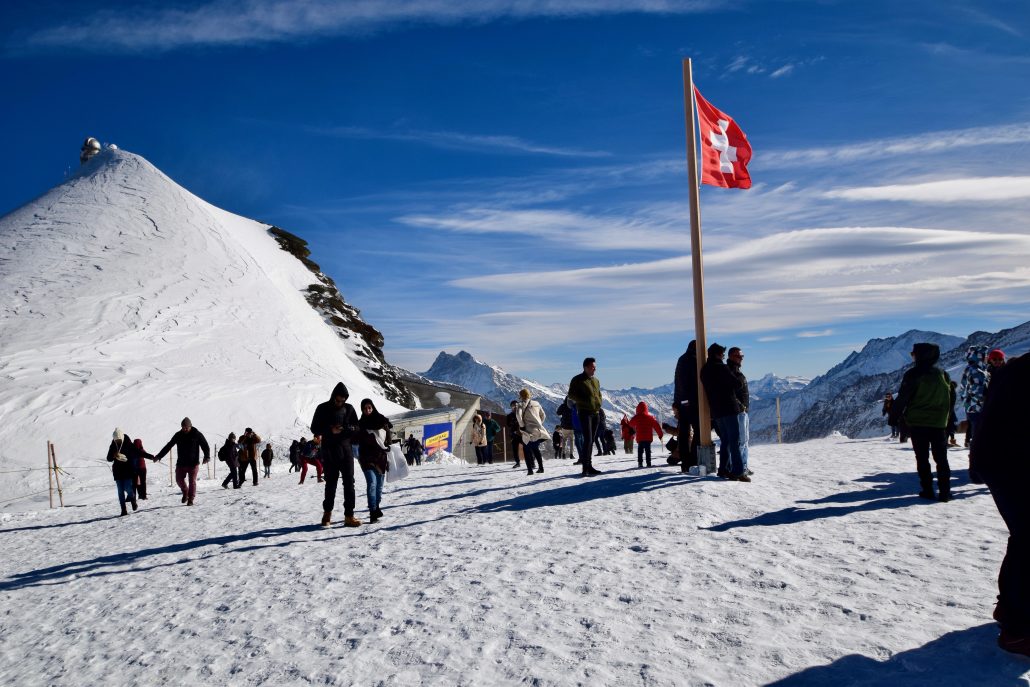 Tourists enjoying stunning views of the Alps at Junfrau, Switzerland.