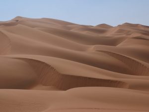 an image of sand dunes in a desert