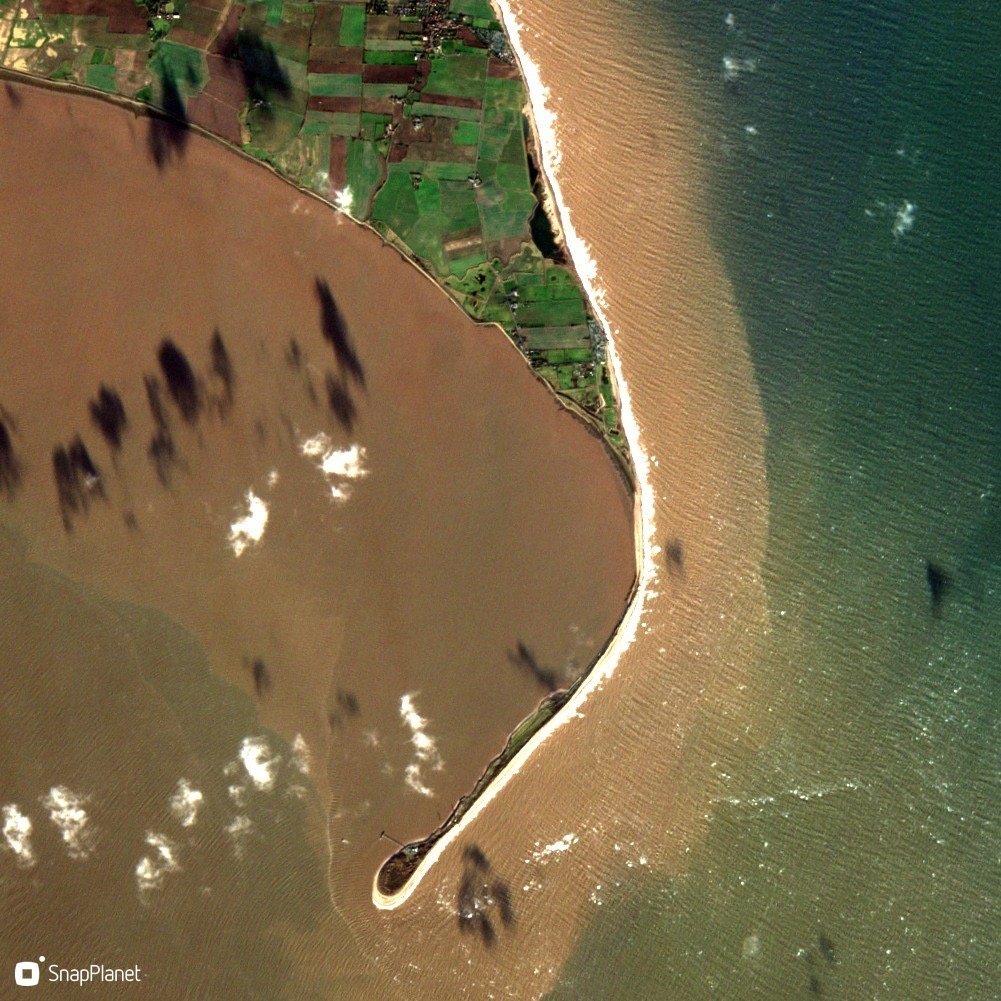 A satellite image showing sediment being transported along the coast at Spurn Point.