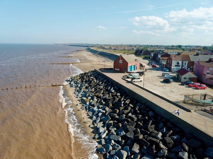 Sea wall, rock armour and groynes at Withernsea - view south