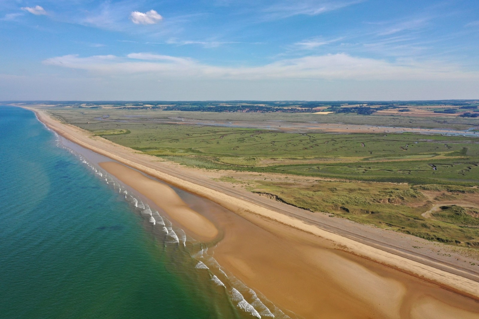 Sediment becomes smaller and sand dunes form as you travel north-west along the spit