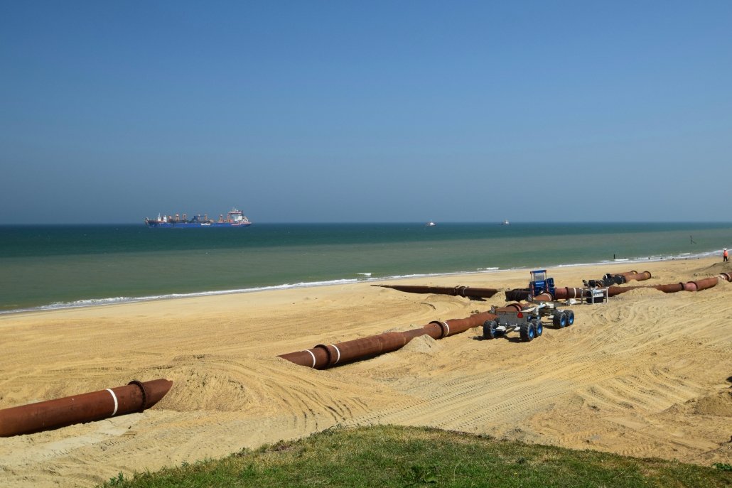 Sediment is pumped to the beach from the dredging vessel.