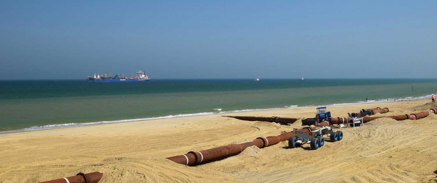 Sediment is pumped to the beach from the dredging vessel.