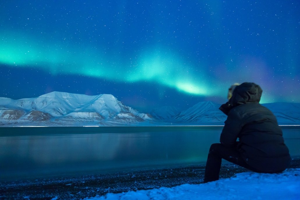 An image of a man looking at the northern lights