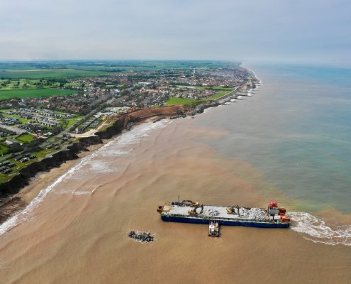 Aerial view of Withernsea and unloading rock armour