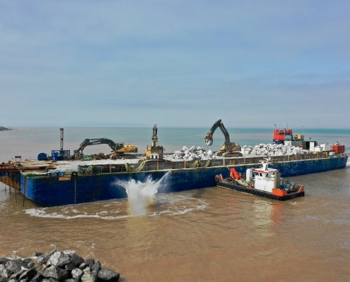 Rock being dropped from a barge