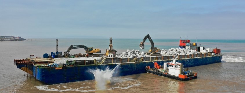 Rock being dropped from a barge