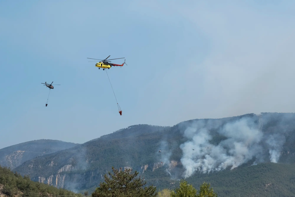 Firefighting helicopters dropping water over a forest fire area on 27th July in Karabuk, Turkey