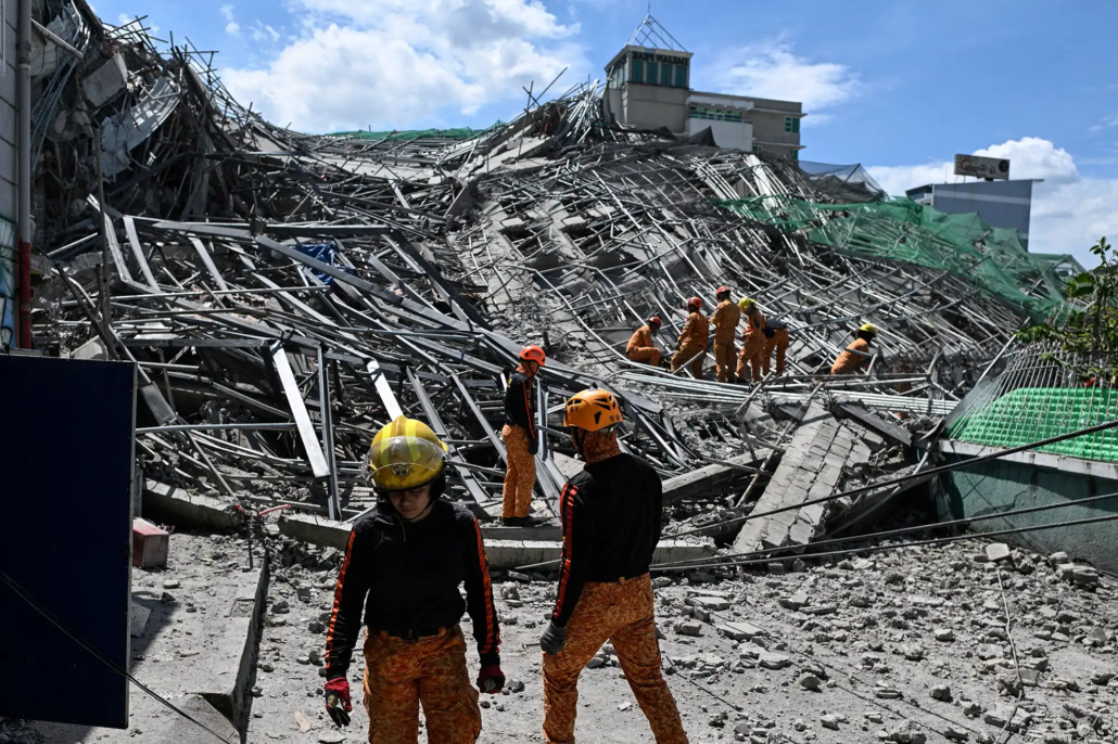 Emergency services work at the site of a collapsed building following the earthquakes in Caracas