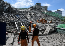 Emergency services work at the site of a collapsed building following the earthquakes in Caracas