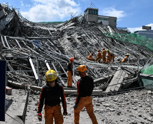 Emergency services work at the site of a collapsed building following the earthquakes in Caracas